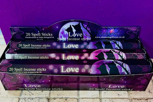 Photo of a box containing several packs of love themed incense sticks.