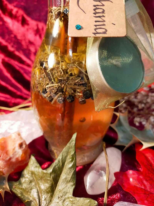 Image of a bottle of bath oil containing herbs and flowers.