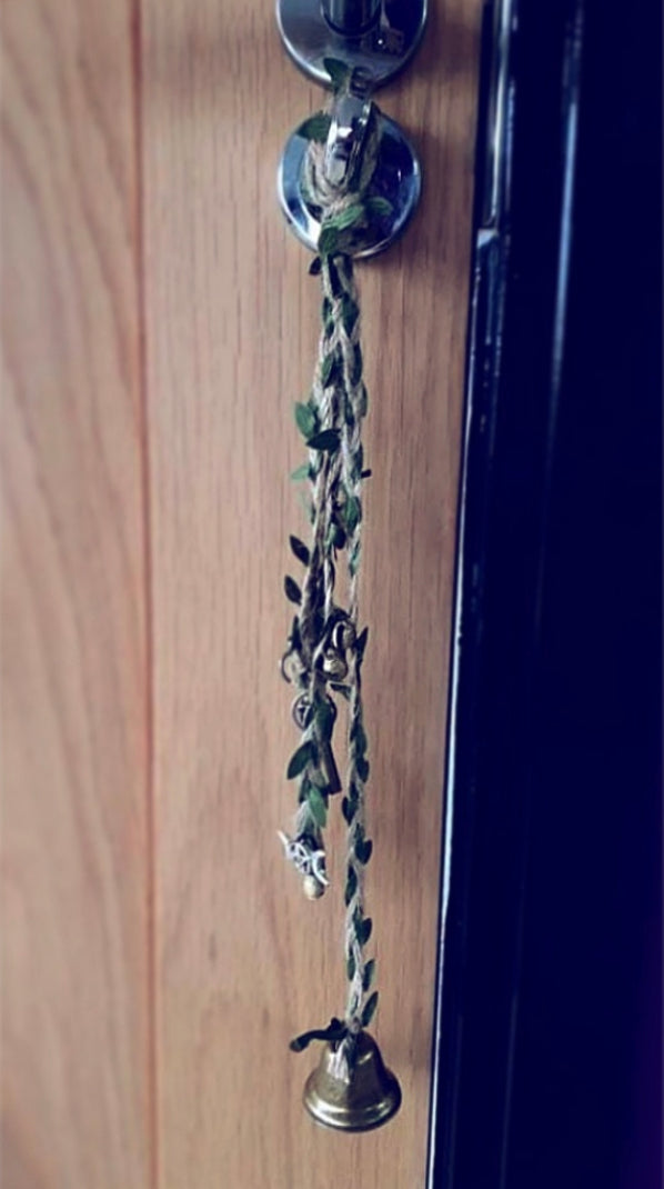 Photo of witch bells hanging from a door handle
