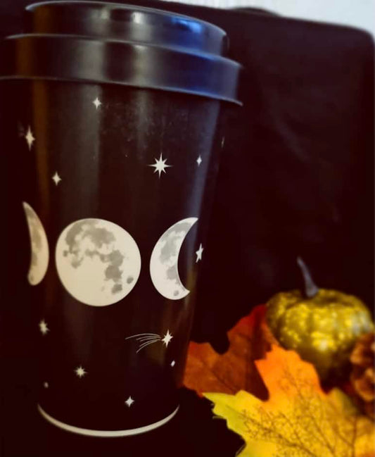 Photo of a black travel mug with a triple moon design