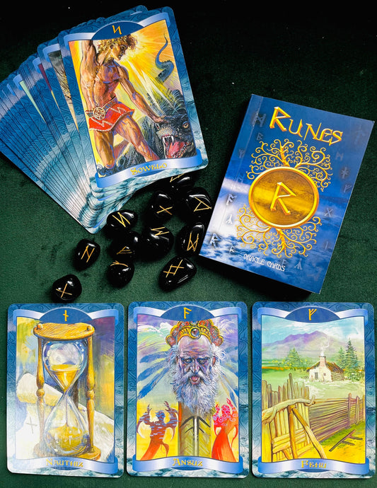 Photo of a three of the cards from the Runes oracle deck laid out, with the rest partially fanned out in the top corner.