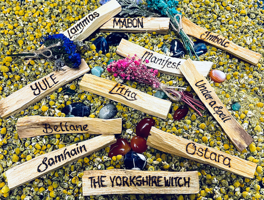 A number of personalised palo santo sticks with inscriptions such as Imbolc, Lammas, Yule and Samhain