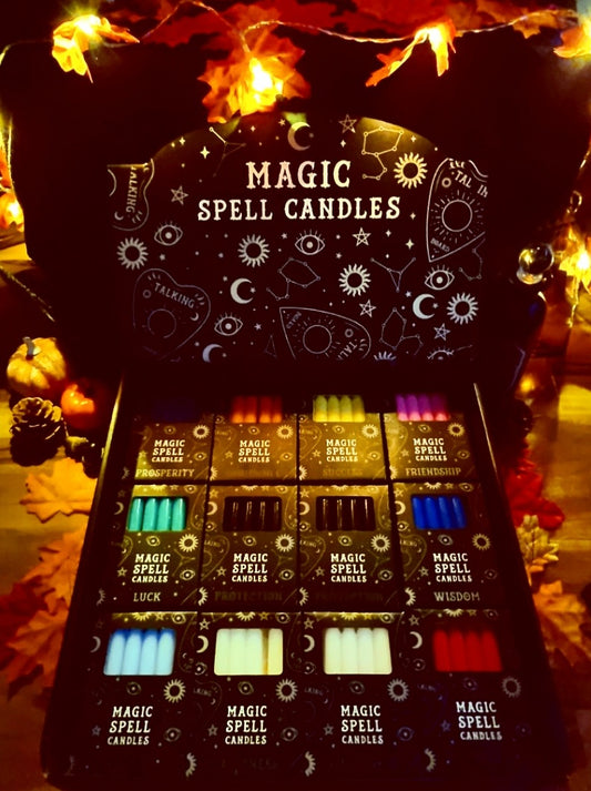 Photo of a display box with twelve packs of magic spell candles in different colours