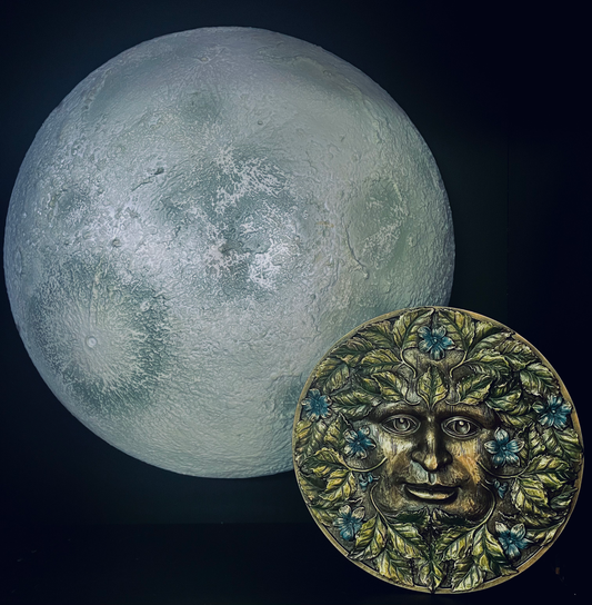Photo of a Beltane wall hanging decoration in front of a moon wall decoration.
