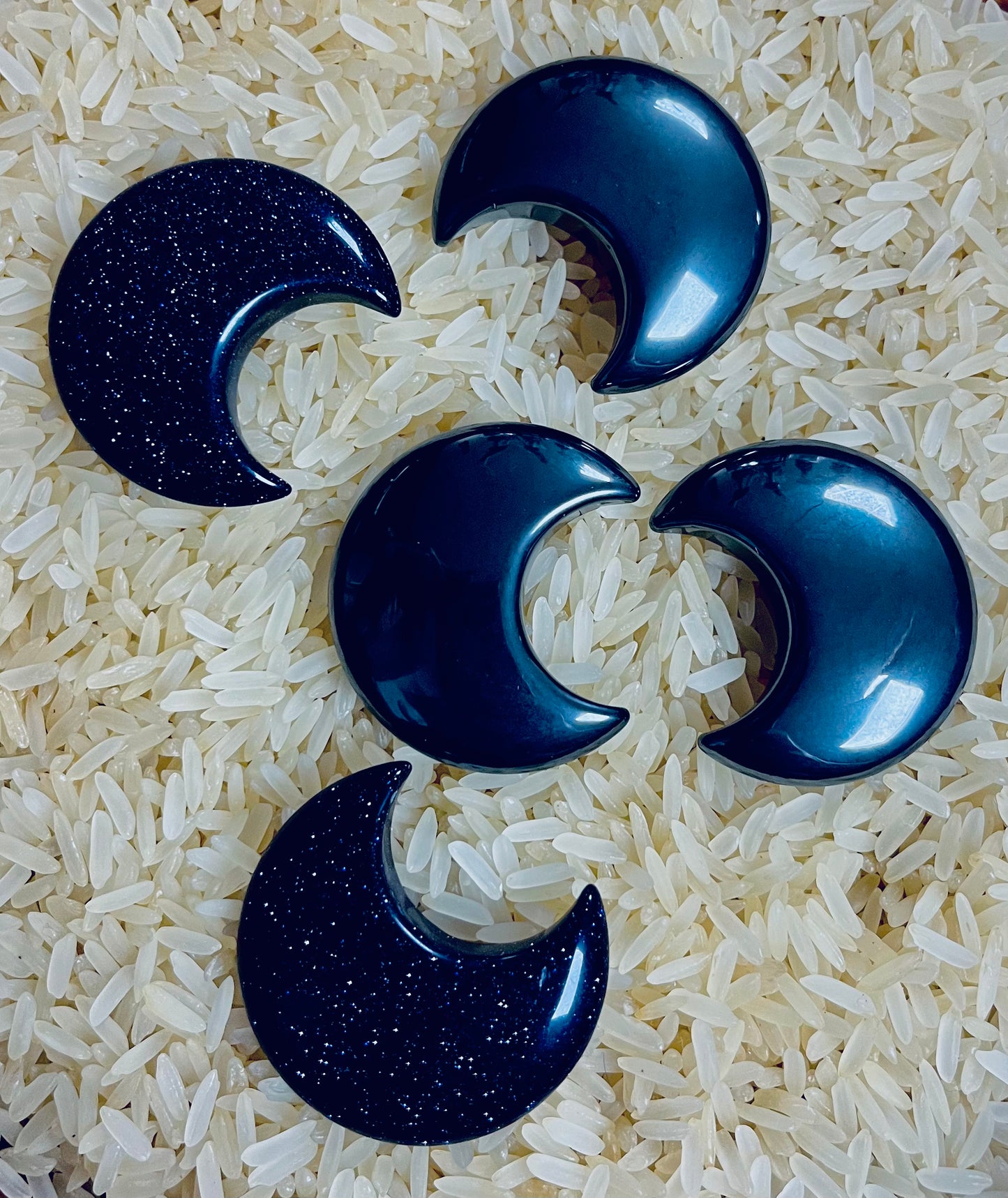 Photograph of five crystal moons in hematite and blue sandstone.