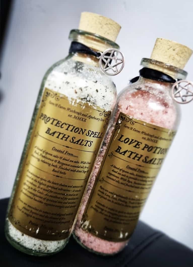 Photo of two bottles of bath salts, one labelled protection and one labelled love potion