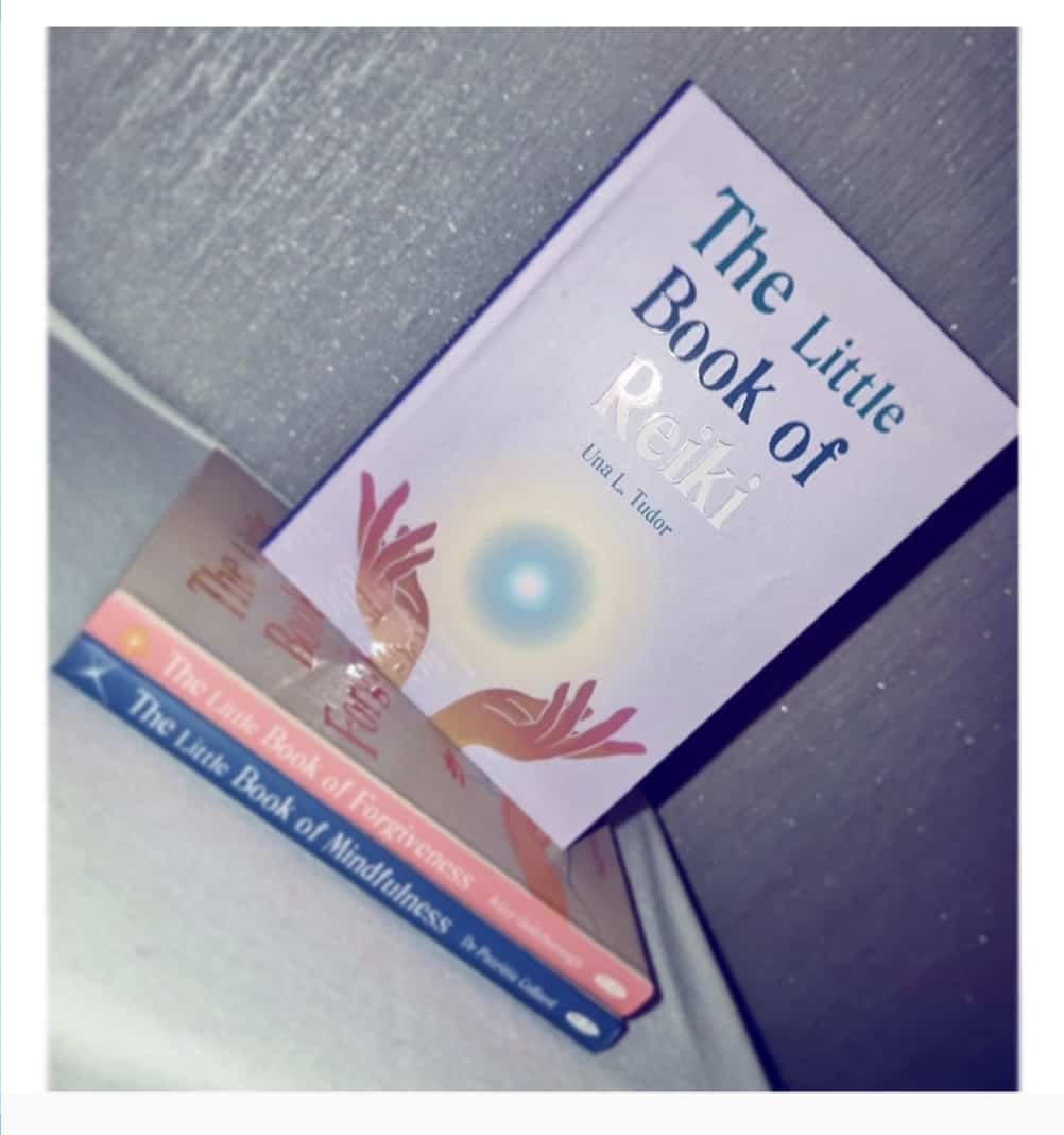 Photo of three Little Book of.. books with the full cover shown of The Little Book of Reiki