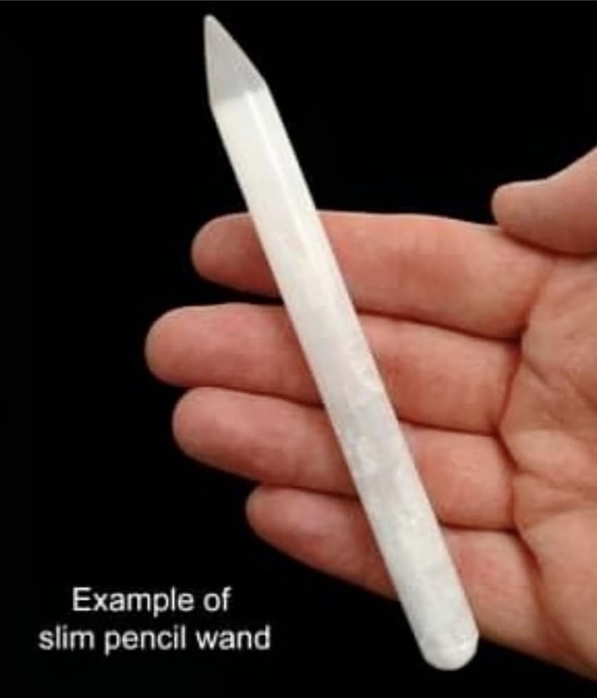 Photo of a selenite pencil wand across someone's fingers. The text reads "Example of size of selenite wand"