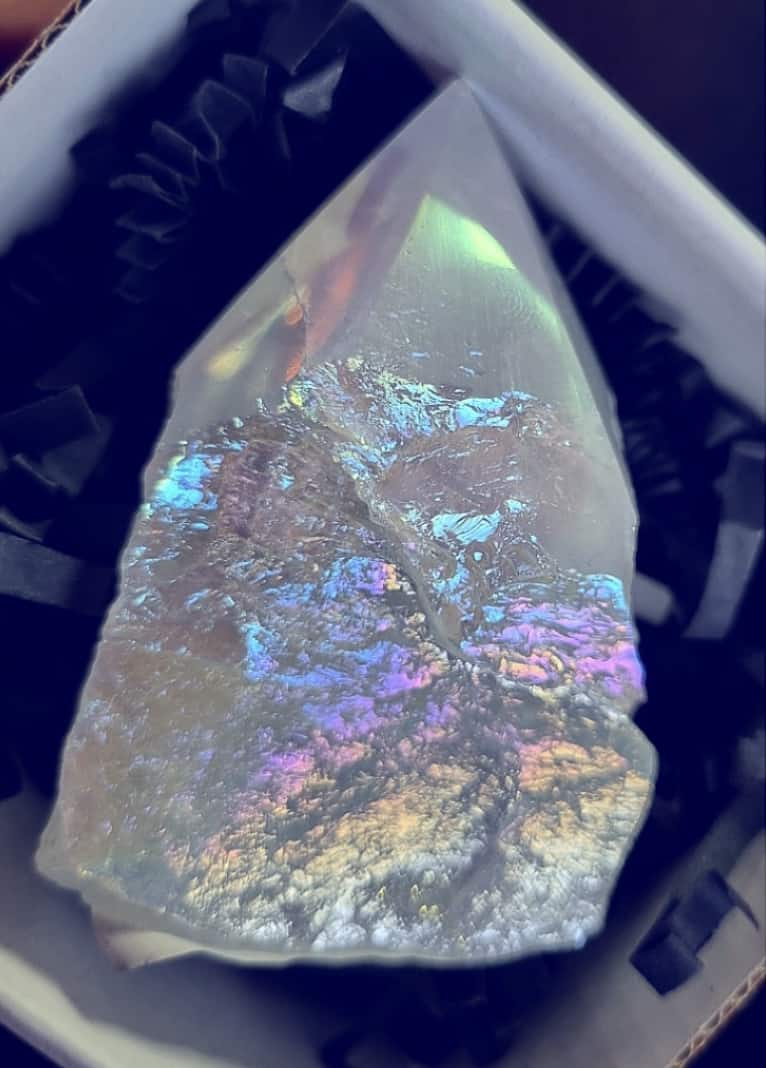 Photo of a snow aura quartz polished point.