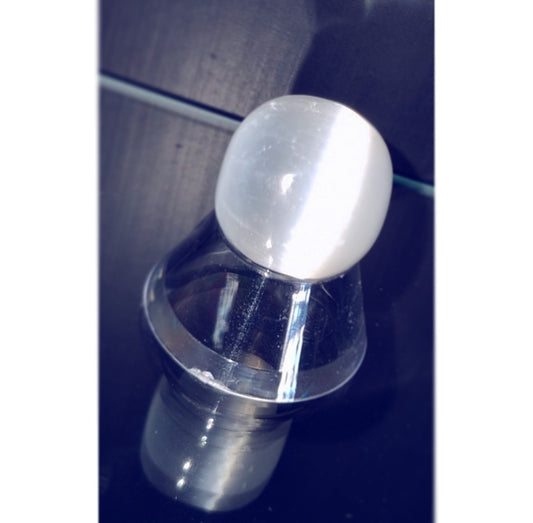 Photo of a small selenite orb on a stand.