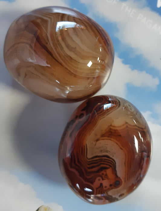 Photo of two natural red banded agate polished pebbles