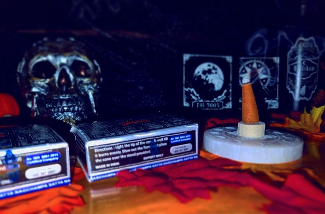 Photo of boxes of dhoop incense cones, alongside a burning incense cone.