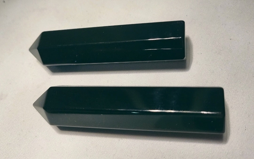 Photo of two black obsidian polished points