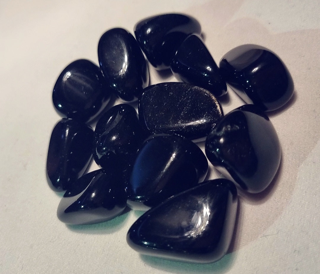 Photo of several black onyx tumblestones