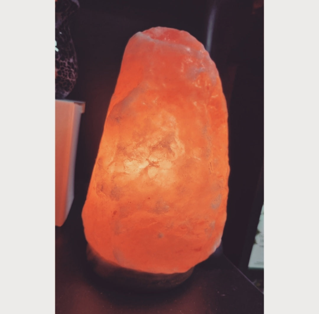 Photo of a lit Himalayan salt lamp.