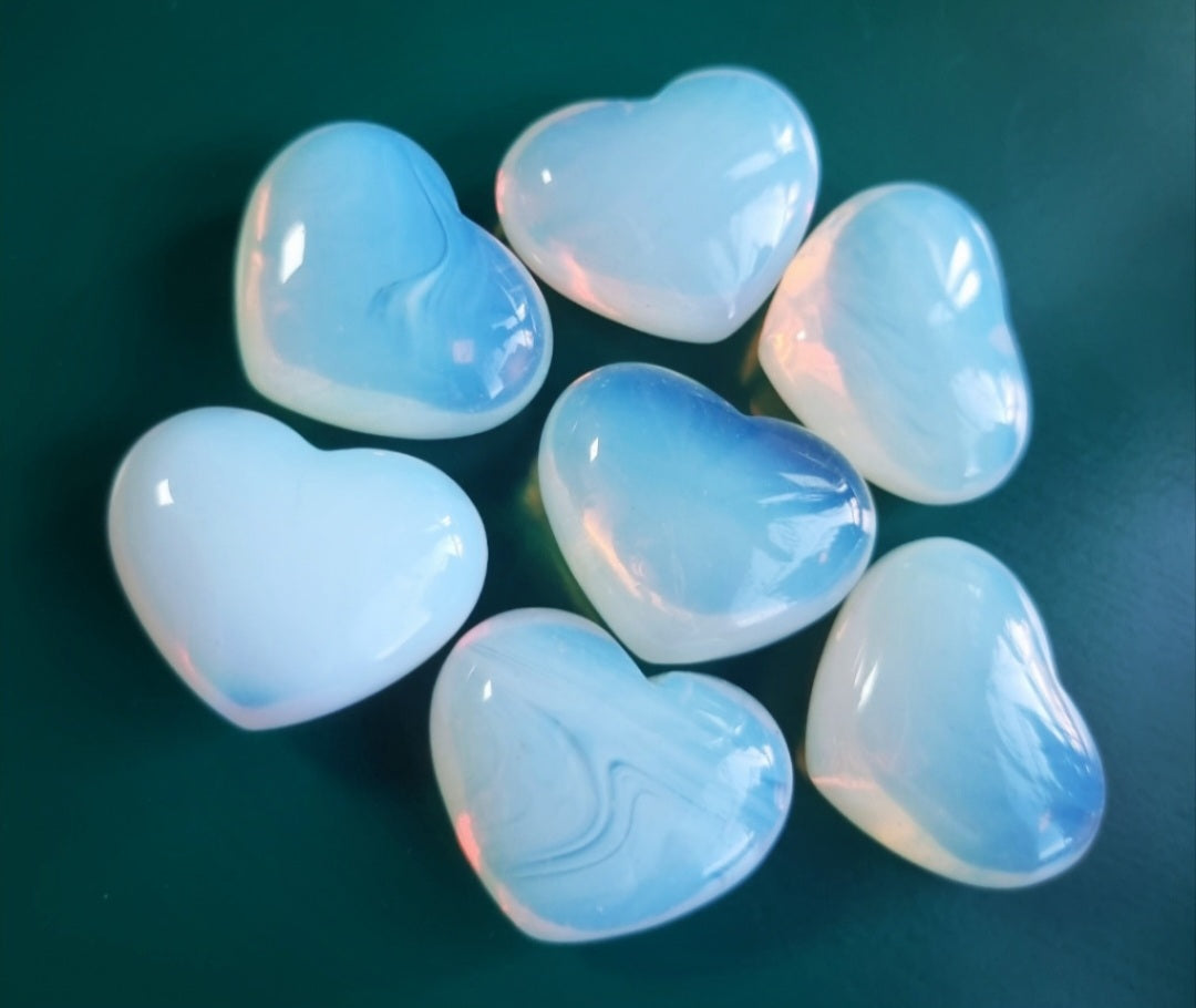 Photo of seven opalite hearts.