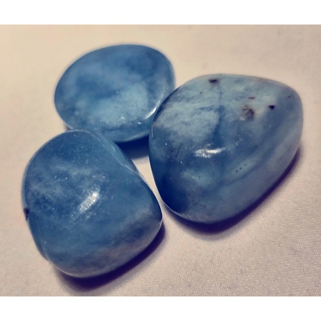 Photo of three aquamarine tumblestones