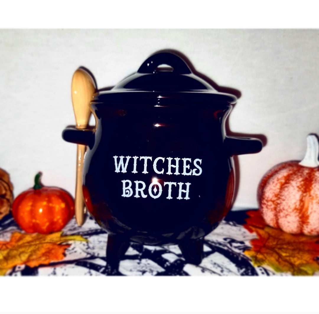 Photo of a black cauldron shaped soup bowl with a lid, with the words "Witches Broth" in white on the front